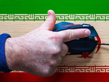 Hand on keyboard with an Iranian flag background