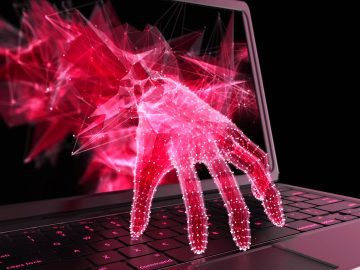 Hand reaching through laptop screen to steal data