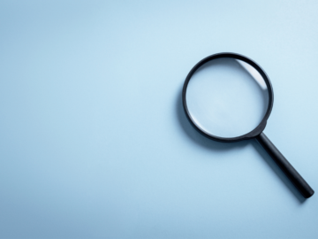 A magnifying glass on a blue background.