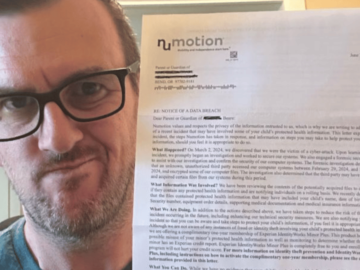 Photo of man holding up letter with information about a data breach