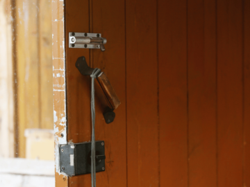 An open door with several locks on it