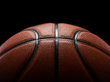 Half a basketball on a dark background