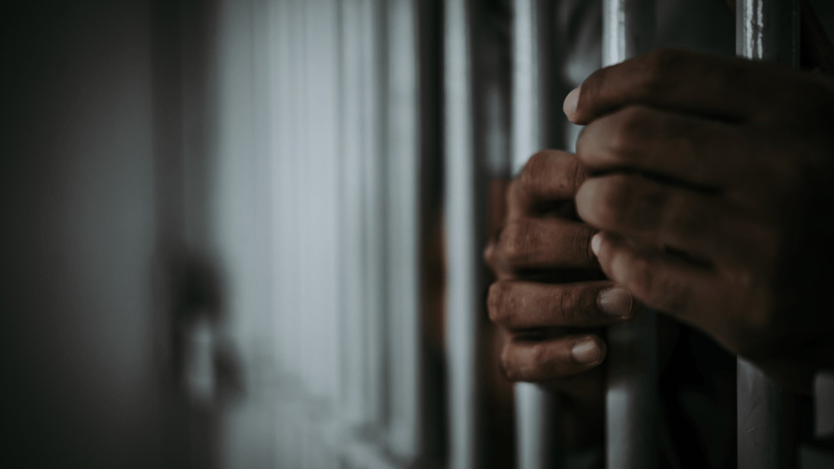 Hands on jail bars