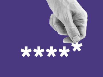 A hand reaches down to grab one asterisk from a written password.