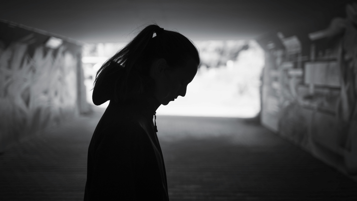 More vulnerable stalkerware victims’ data exposed in new TheTruthSpy flaw Silhouette of woman in underpass looking down at the ground