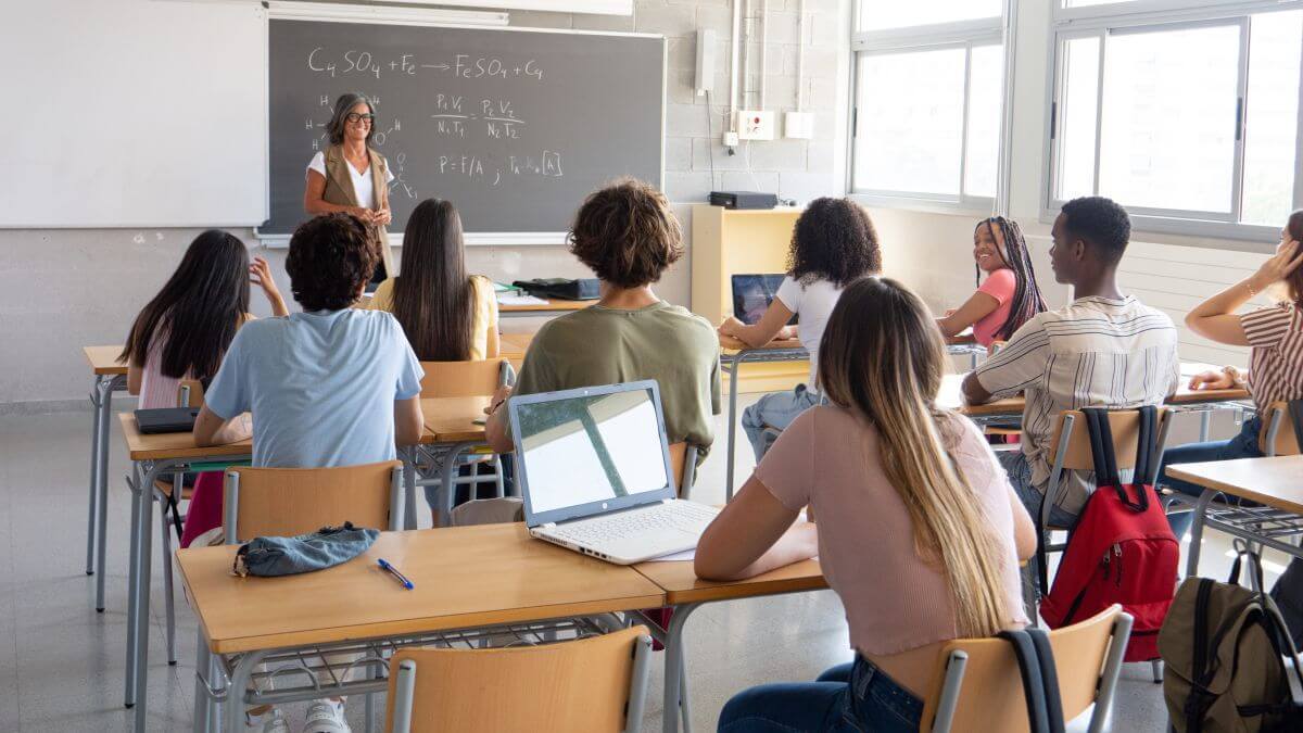 “A dare, a challenge, a bit of fun:” Children are hacking their own schools’ systems, says study A group of students looking toward a teacher at the front of a classroom