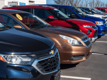 A line of different cars in a parking lot